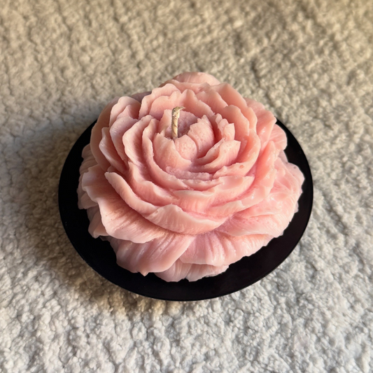 Pink rose-shaped object on a textured surface
